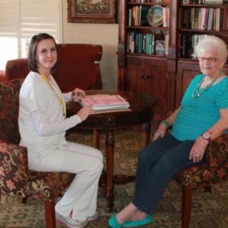 Two women sitting in a living room engaged in conversation.