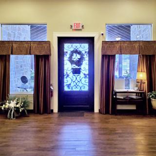 A welcoming entrance featuring a decorative door and elegant curtains.