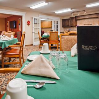 A cozy restaurant dining area with neatly set tables and chairs, featuring a menu on the table.