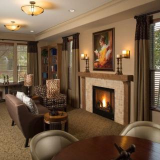 A cozy living room with a fireplace and comfortable seating.
