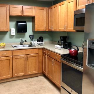 Modern kitchen with wooden cabinets and stainless steel appliances.