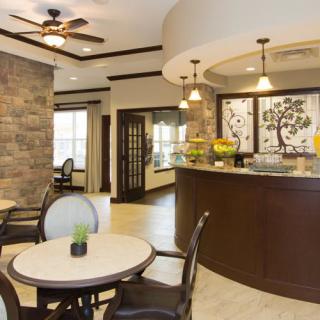 A modern lobby featuring a seating area and a reception desk with elegant decor.