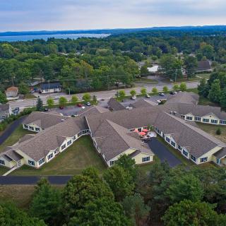 Aerial view of a residential building complex surrounded by trees.