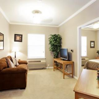 A cozy living room with a sofa, television, and decorative elements.