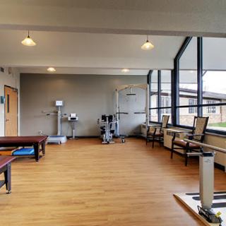 A bright and modern physical therapy room equipped with exercise tools and a welcoming atmosphere.