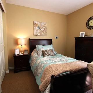 Cozy bedroom with a single bed and warm decor.