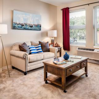 A cozy living room with a beige sofa, coffee table, and decorative elements.