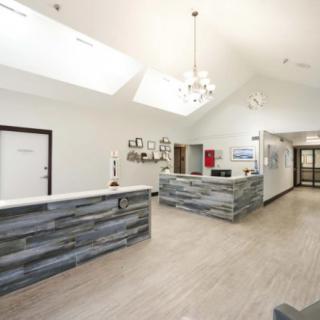 A modern reception area with sleek wood accents and skylights.