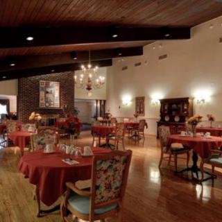 A cozy and elegant restaurant interior with neatly arranged tables and a warm atmosphere.