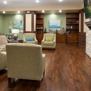 A modern living room with comfortable seating, wood flooring, and tasteful decor.