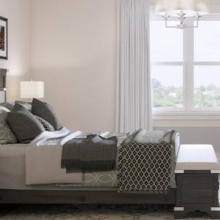 A modern bedroom with stylish decor and a large window.
