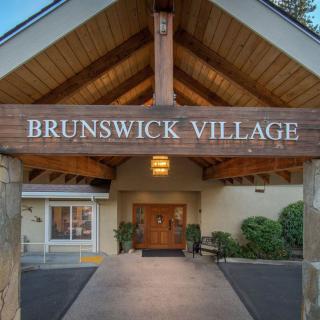 The entrance to Brunswick Village with a welcoming wooden facade.