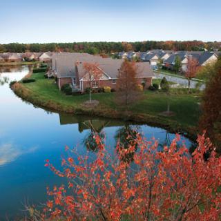 A serene view of a lakeside community showcasing the vibrant colors of autumn.
