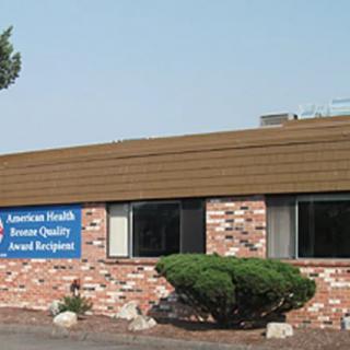 A brick building with a sign indicating it is an American Health Care Association Quality Award recipient.