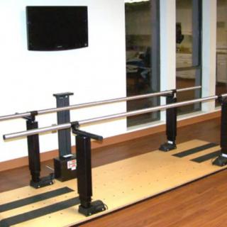 A set of parallel bars in a physical therapy room, used for rehabilitation exercises.
