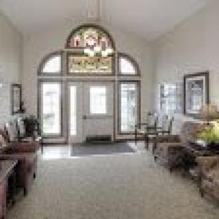 A spacious entryway with elegant decor and large windows.