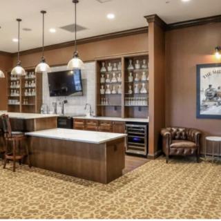 A stylish bar interior with ample shelving and seating.
