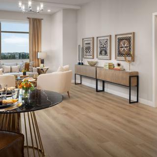 A modern living room and dining area with contemporary furnishings and neutral tones.