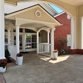 A welcoming entrance featuring elegant columns and a well-maintained outdoor area.