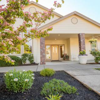A well-maintained residential house with a landscaped garden and inviting entrance.