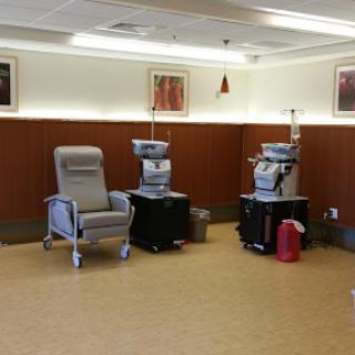 A treatment area in a healthcare facility equipped with infusion chairs and medical equipment.