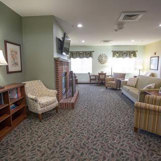A cozy living room with a fireplace, television, and comfortable seating.