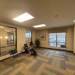 A spacious and modern waiting area with comfortable seating and large windows.