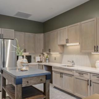 A modern kitchen with wooden cabinets and a central island.