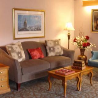 A cozy living room with a sofa, coffee table, and decorative elements.