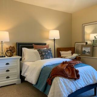 A cozy and well-decorated bedroom with warm lighting and stylish furnishings.