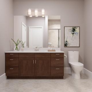 A modern bathroom featuring a wooden vanity with a large mirror, contemporary lighting, and minimalistic decor.