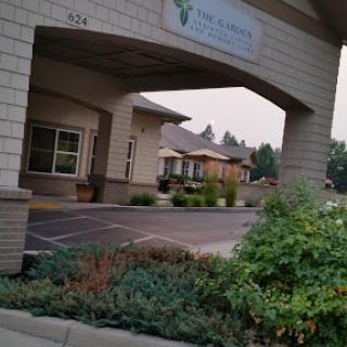 A welcoming entrance to a building with landscaped surroundings.