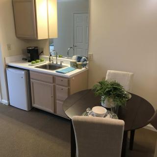 Cozy kitchen area with a small dining table and chairs.