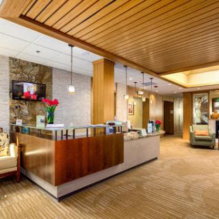 A welcoming and modern lobby reception area with wooden accents and soft lighting.