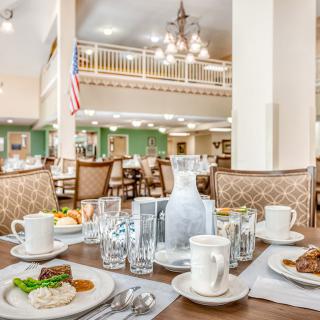An elegant dining area with a well-set table and decorative interior.
