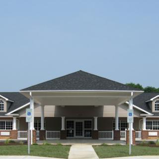 A modern building with a prominent entrance and covered porch.