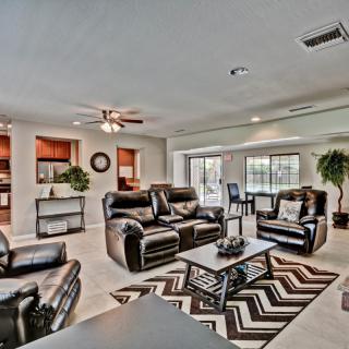 A modern living room with leather sofas and an open floor plan.