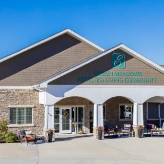 The entrance of a healthcare facility with a modern exterior design under a clear blue sky.
