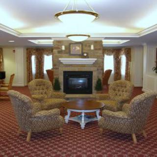 A cozy living room with a fireplace surrounded by comfortable seating.