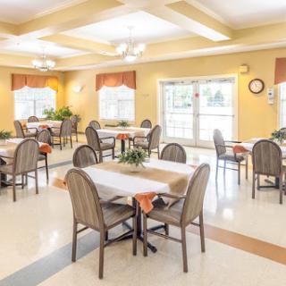 A spacious and inviting dining area with tables and chairs arranged for a comfortable meal experience.
