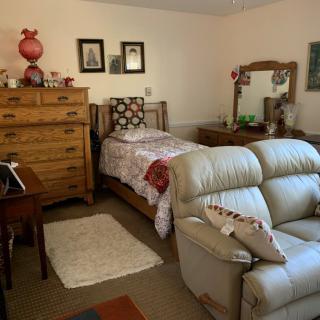 A cozy bedroom with traditional furniture and decor.