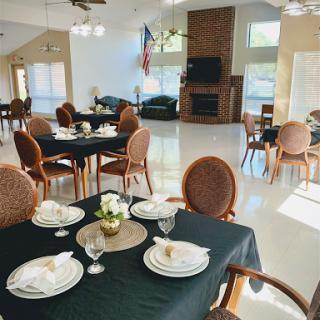 A beautifully arranged dining area featuring black tablecloths and elegant table settings.