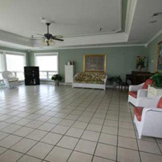 Spacious living room with tiled flooring and elegant decor.