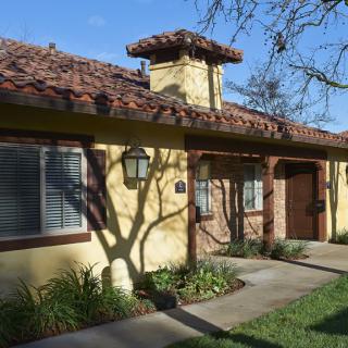 A Spanish-style residential house with a tiled roof and well-maintained landscaping.