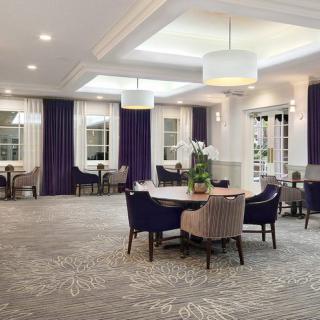A modern dining room with elegant decor and ample natural light.