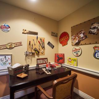 A cozy office space with vintage decor and retro wall art.