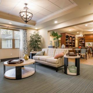 A modern living room with a sofa, coffee table, and open layout allowing natural light.