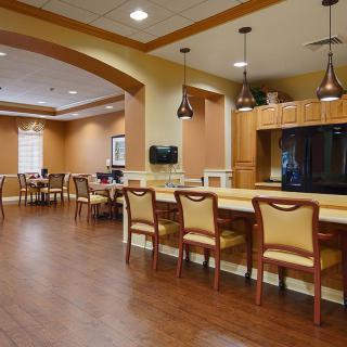 Spacious dining and kitchen area with wooden floors and modern lighting.