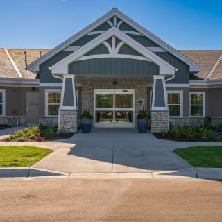 Front view of a modern residential building with a landscaped entrance.