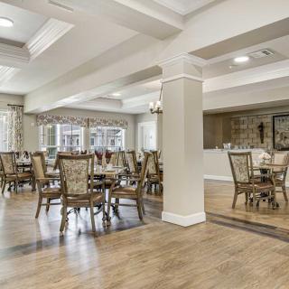 A spacious dining area with elegant furnishings and natural lighting.